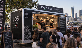 joes pizza trailer with busy crowd situated in melbourne city at an event