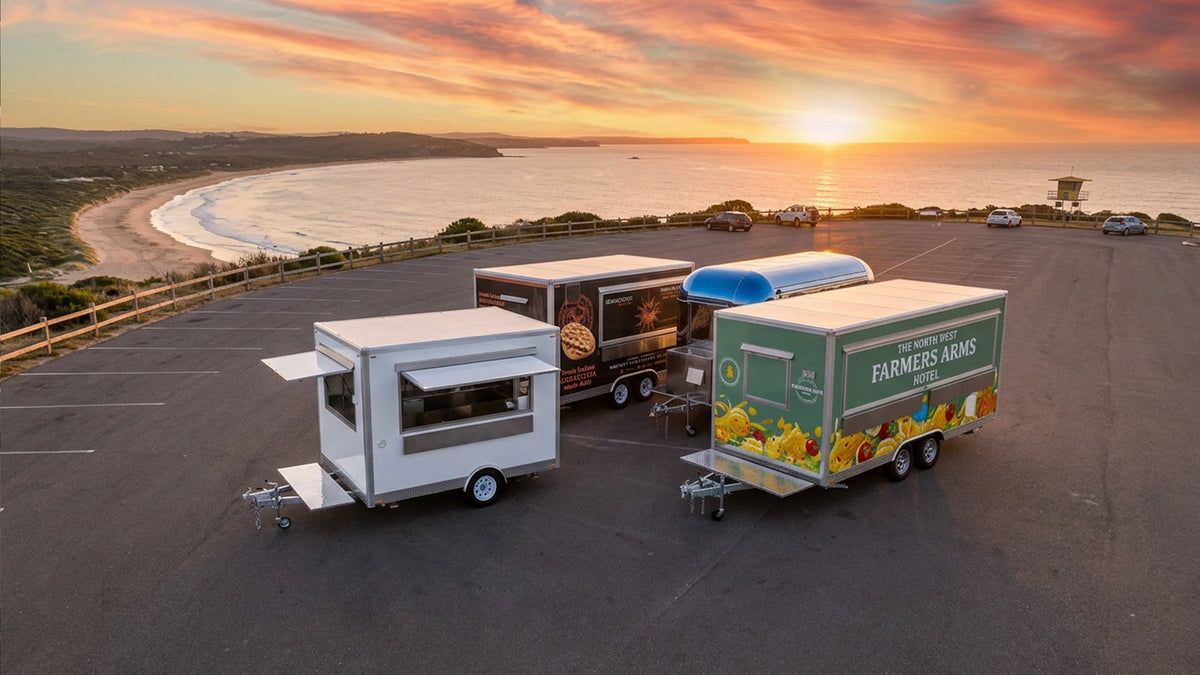 three trailers outside in a car park with a sunset