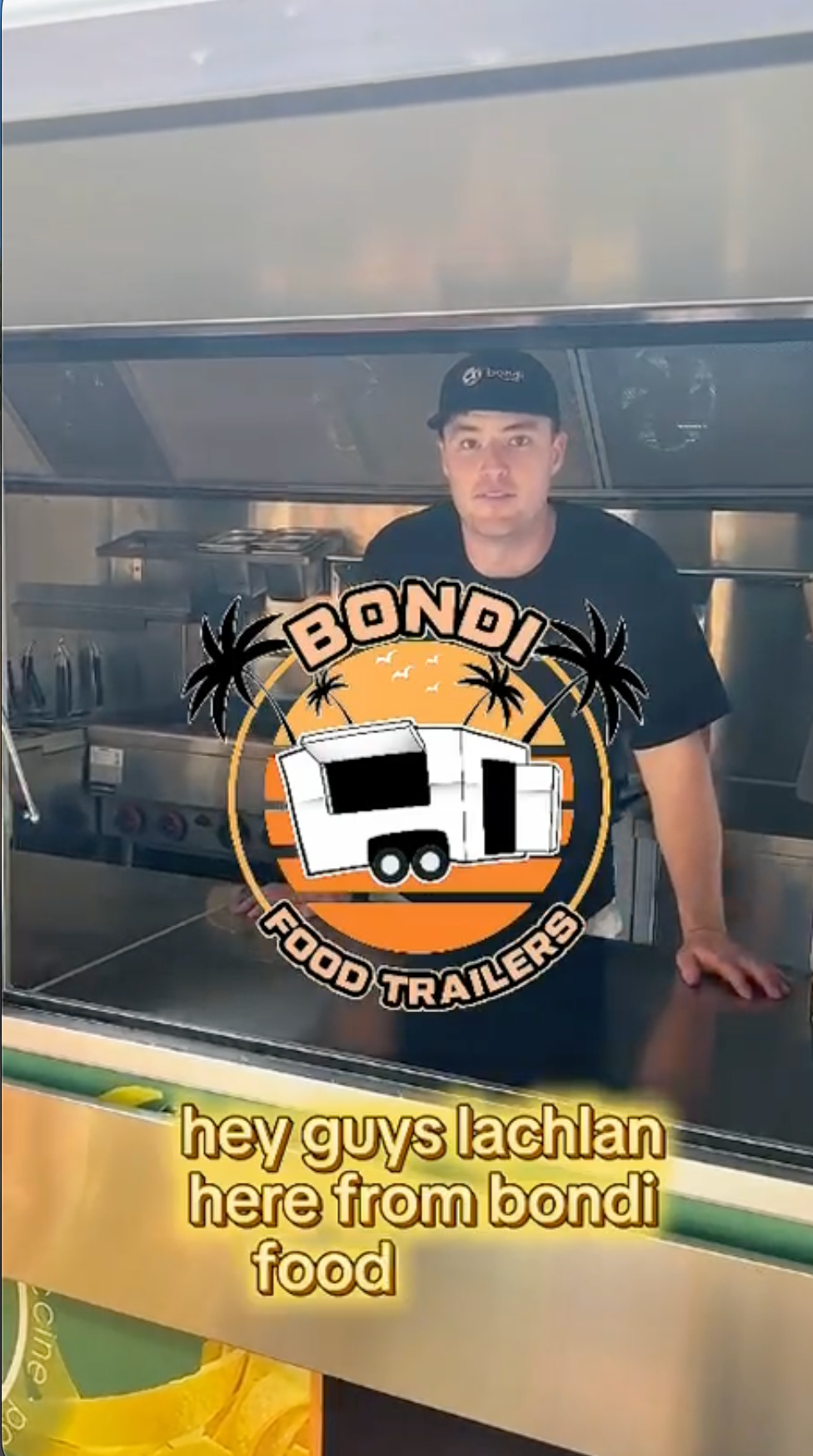 bondi food trailer owner lachlan in the window of a food trailer showcasing the mobile kitchen